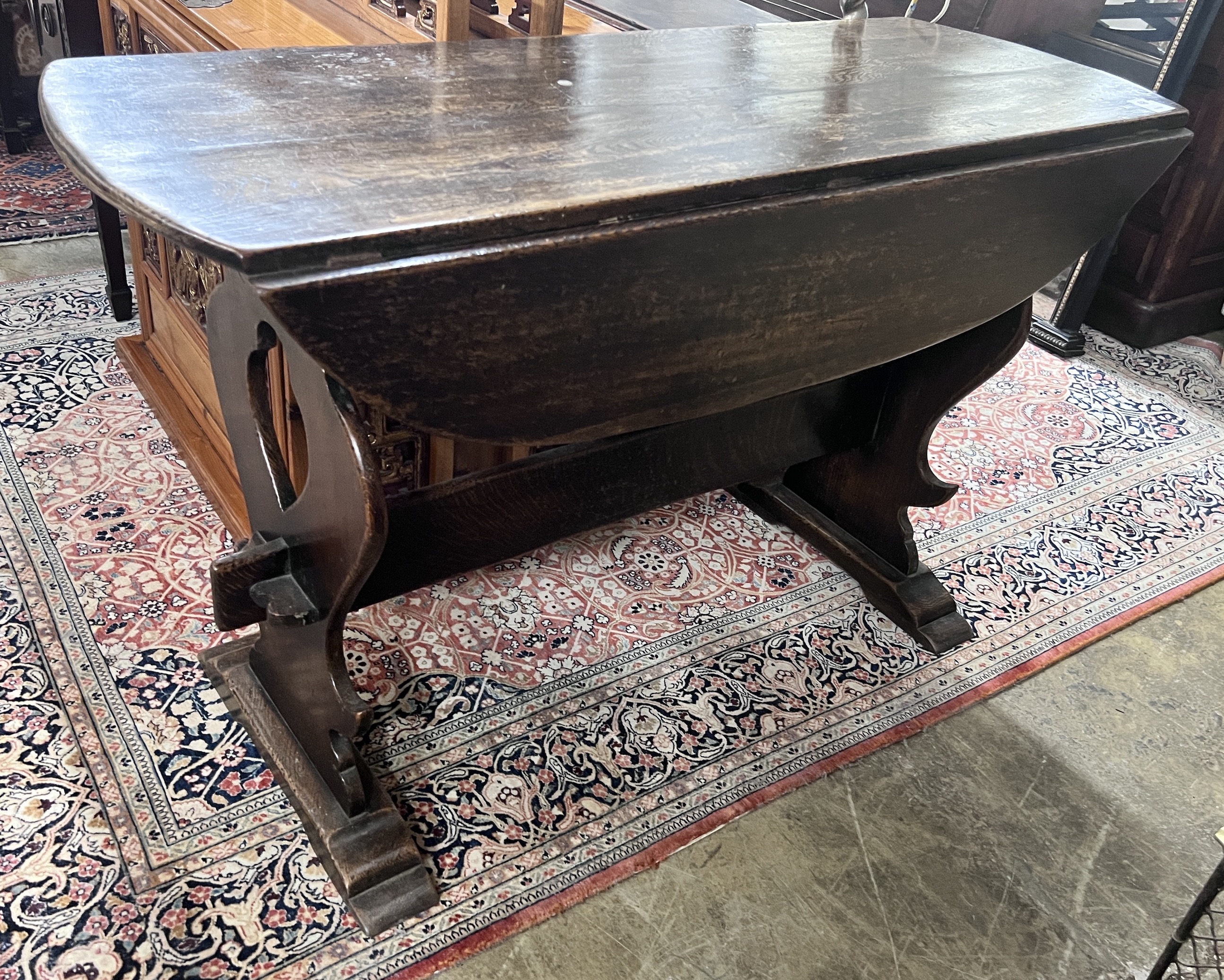 An 18th century style Spanish design oak drop leaf dining table, length 122cm, depth 45cm, height 76cm